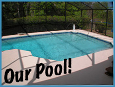A backyard swimming pool is enclosed by a screened structure. The words "Our Pool!" are written in large, playful letters at the bottom left corner of the image. The pool area is surrounded by trees and greenery in the background.